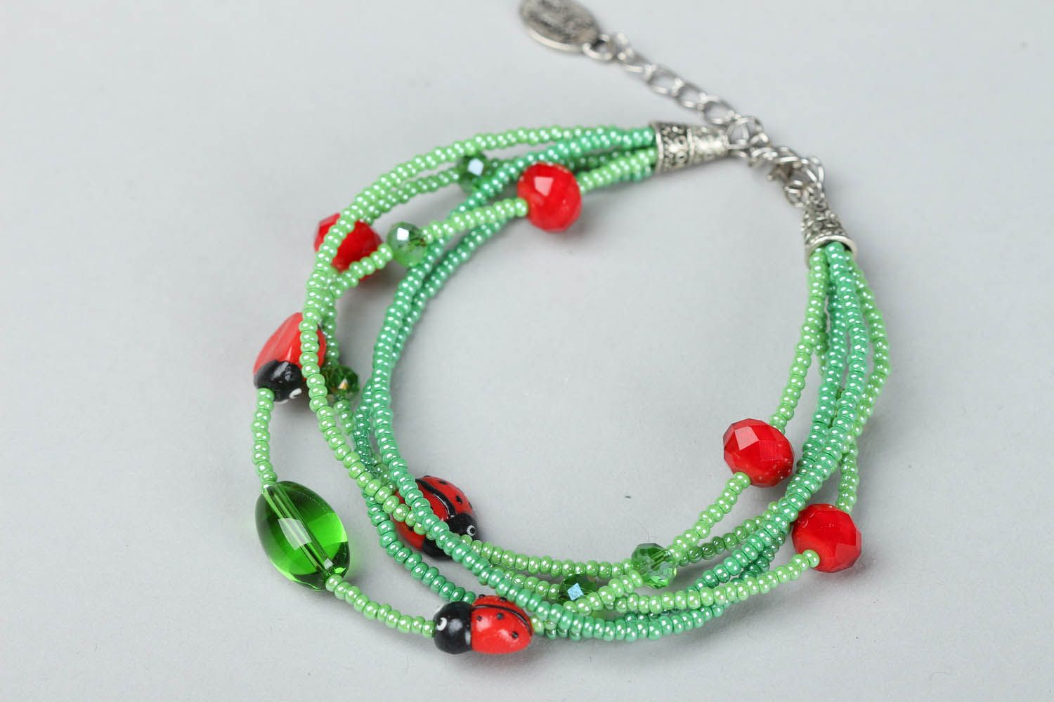 Green bracelet with ladybugs photo 1