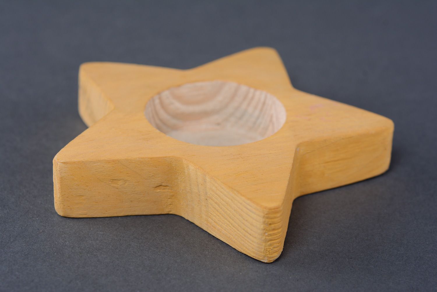 Candelero de madera con forma de estrella amarilla foto 1