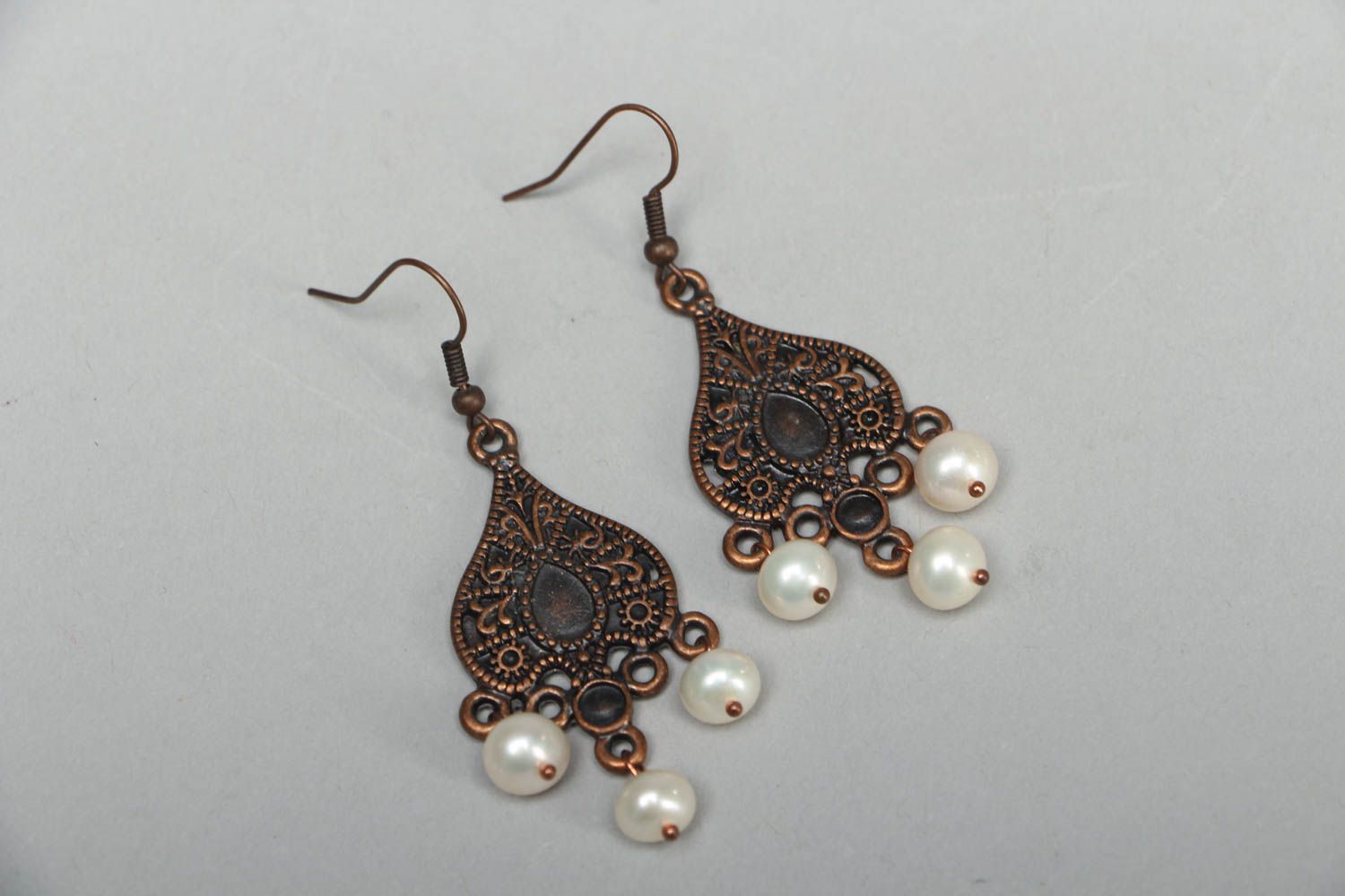 Metal earrings in Orient style with pearl-like beads photo 1