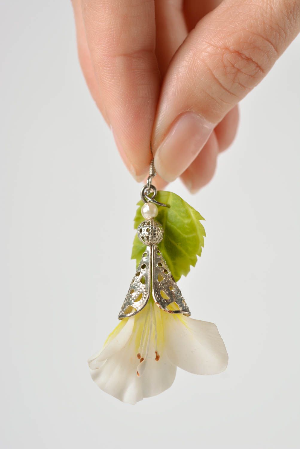 Handmade long earrings with white flowers and green leaves on metal basis photo 4