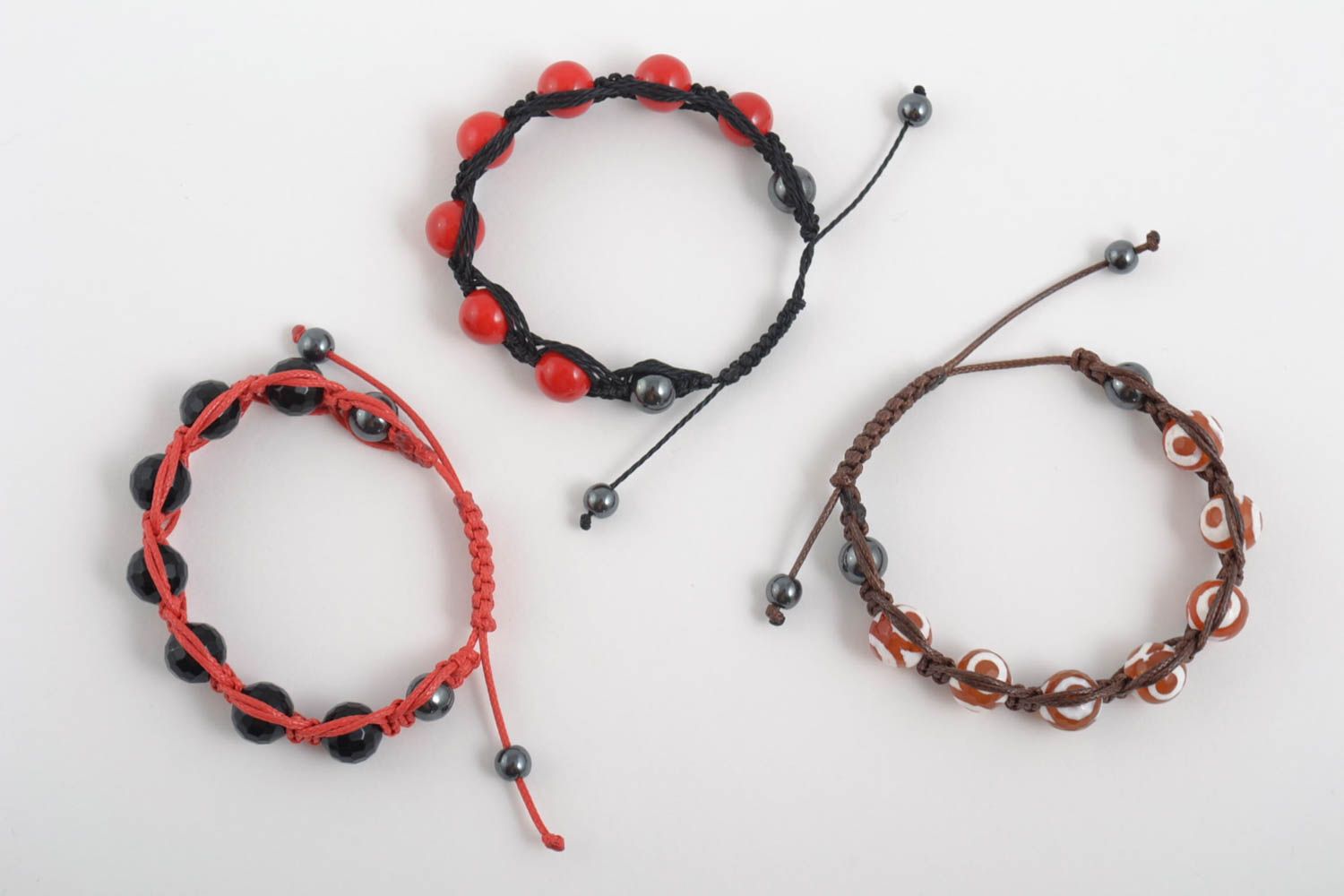 Set of three strand bracelets on red, brown, black cords with red, black, white, and brown beads for women photo 2
