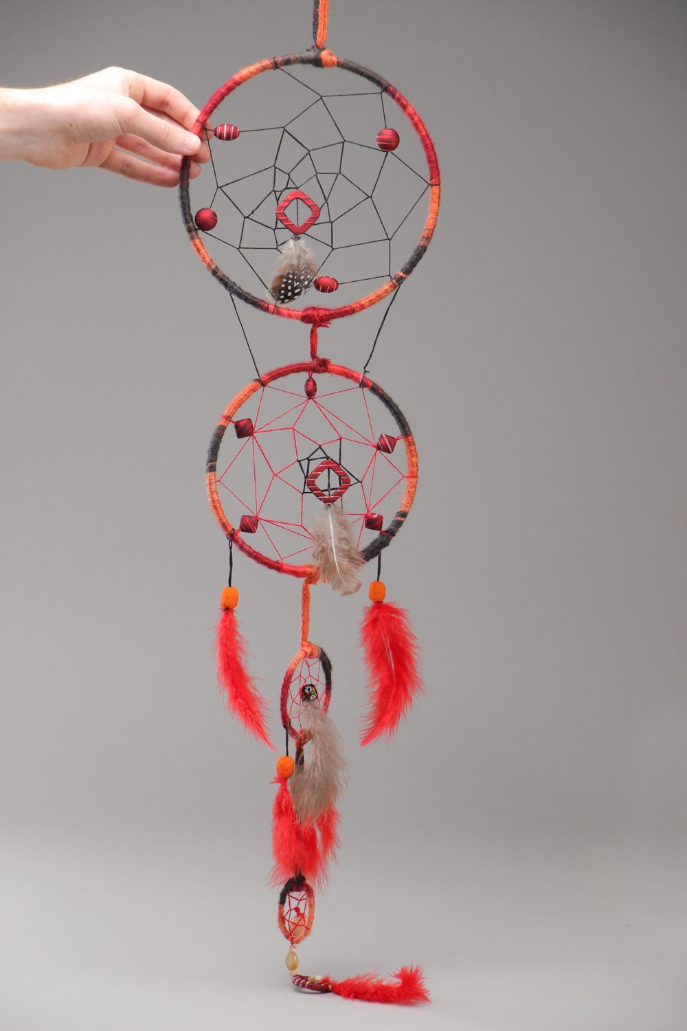 Long red homemade dreamcatcher wall hanging with natural stones and feathers photo 5
