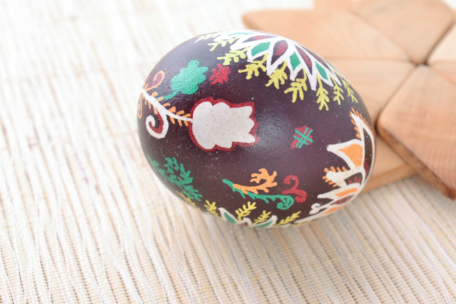 Handmade designer painted Easter egg with floral ornaments on dark background photo 1