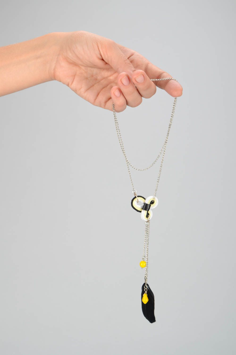 Pendant with feather on a long chain photo 2
