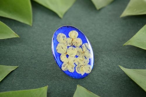 Handmade oval ring with dried flowers on bright blue basis in epoxy resin - MADEheart.com