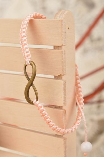 Handmade stylish thin pink woven wrist bracelet made of silk with insert - MADEheart.com