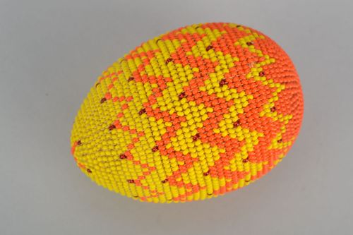 Wooden egg woven over with orange beads - MADEheart.com