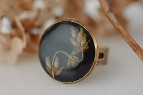 Handmade festive black round womens ring with flower coated with epoxy resin  - MADEheart.com