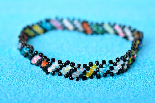Thin handmade beaded bracelet made of black, green, red yellow beads for young girls - MADEheart.com
