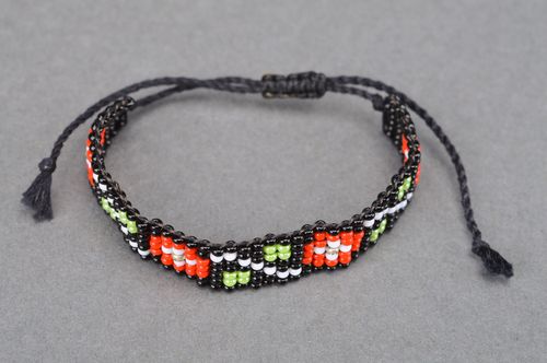 Handmade wide beaded wrist bracelet of black color with ornament and ties - MADEheart.com