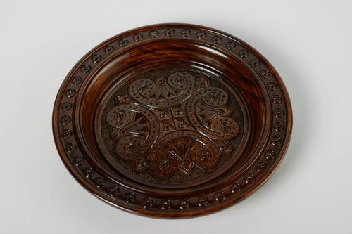 Handmade designer varnished wooden wall plate with art carving of dark color - MADEheart.com