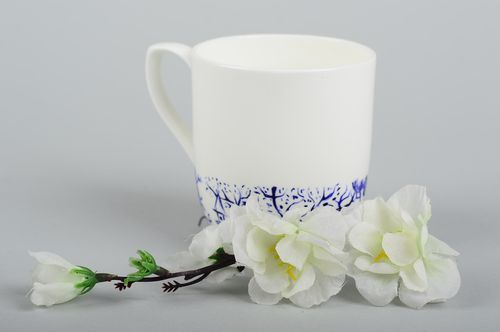White porcelain tea cup with handle and handpainted blue pink painted pattern - MADEheart.com