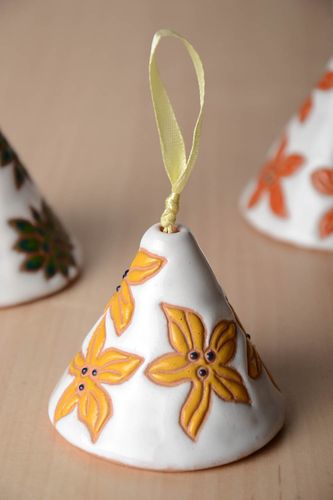 Handmade decorative ceramic bell painted with yellow flowers on white background - MADEheart.com