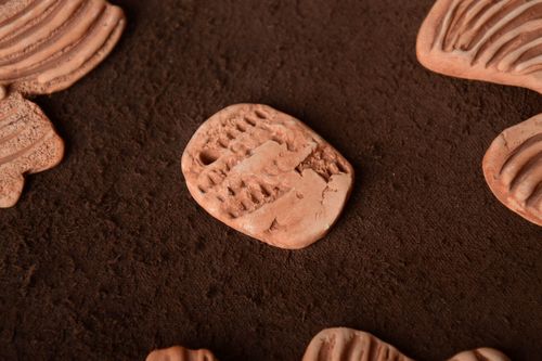 Homemade small ceramic jewelry element with opening for pendant making - MADEheart.com